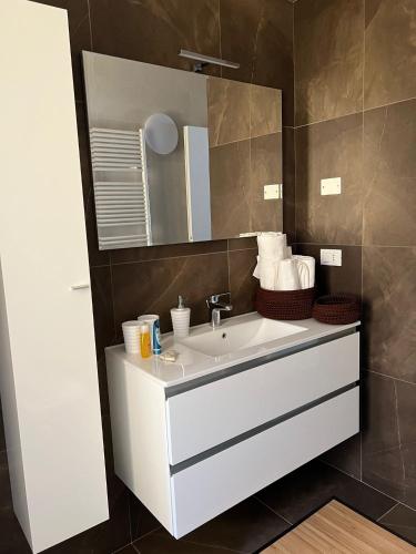 a bathroom with a white sink and a mirror at La Rotonda in Castro