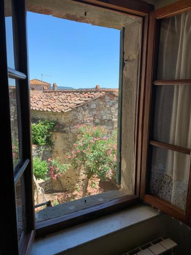 an open window with a view of a garden at Dolcevita Chianti Apartments in Radda in Chianti