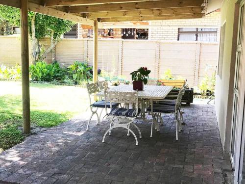 a patio with a table and chairs on a patio at Sedgefield Lagoon Hideout - Kingfisher Drive in Sedgefield
