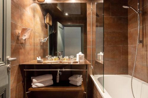 La salle de bains est pourvue d'une baignoire, d'un lavabo et d'un miroir. dans l'établissement Carmel 1643, à Arbois