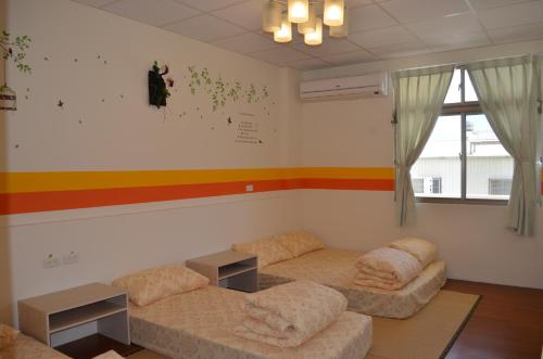 a living room with two couches and a rainbow on the wall at 花蓮阿羅國際青年旅舍民宿 in Hualien City