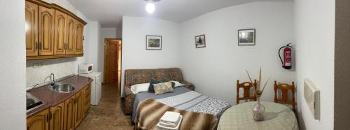 uma cozinha com uma cama e um lavatório num quarto em Coronichi em Montefrío