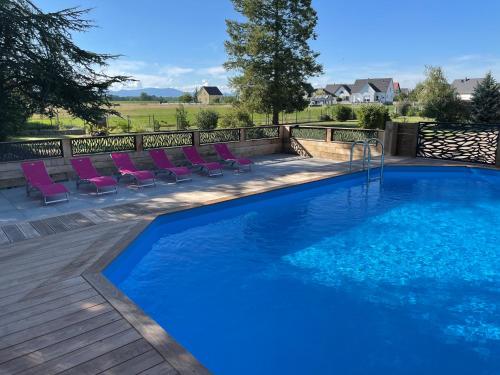 - une piscine avec des chaises longues à côté d'une clôture dans l'établissement Le Clos Ô Daims, à Widensolen