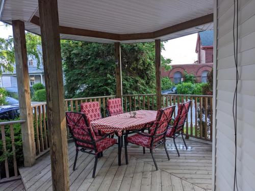a patio with a table and chairs on a deck at Garden 2 Storey House in Niagara Falls