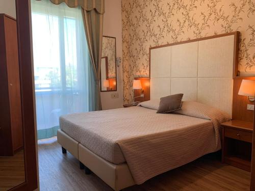 Postel nebo postele na pokoji v ubytování Hotel Apollo