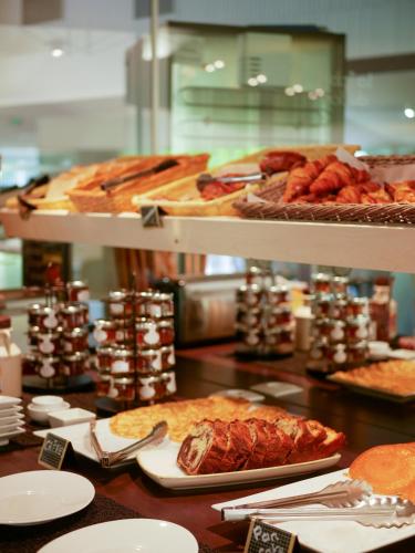 a buffet line with different types of food on display at Best Western Le Bois de la Marche in Poitiers