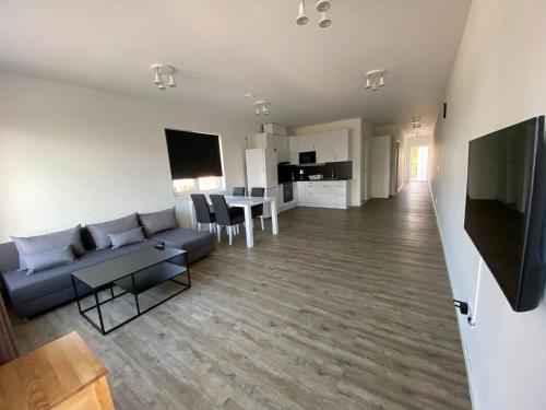a living room with a couch and a table at Solberga lägenhetshotell in Köpingsvik