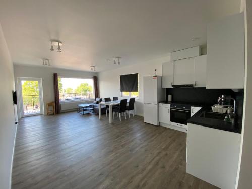 a kitchen and living room with a table and chairs at Solberga lägenhetshotell in Köpingsvik