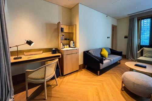 a living room with a couch and a table at voco Nanjing Garden Expo by IHG in Nanjing