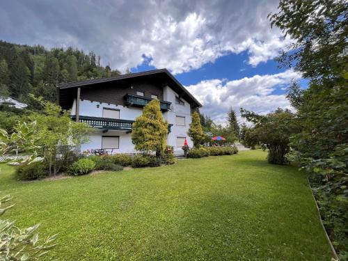 a house with a green lawn in front of it at Apartment Alpenrose Apartment 2 by Interhome in Sankt Urban