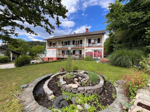 a garden in front of a house at Apartment Meran-2 by Interhome in Görtschach
