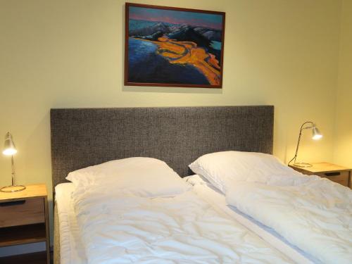 ブルハーフェにあるHoliday Home Klipper by Interhomeの壁に絵画が描かれたベッドルームのベッド1台
