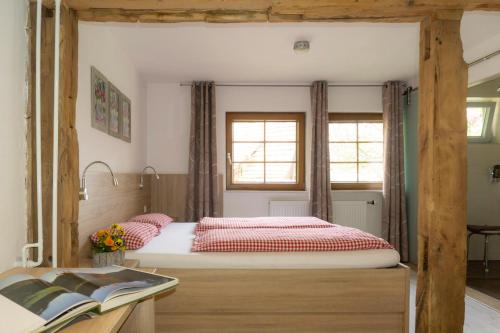 a bedroom with a large bed with red pillows at Naturhotel Holzwurm in Sasbachwalden