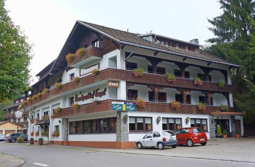 a large building with cars parked in front of it at Alemannenhof Hotel Engel in Rickenbach
