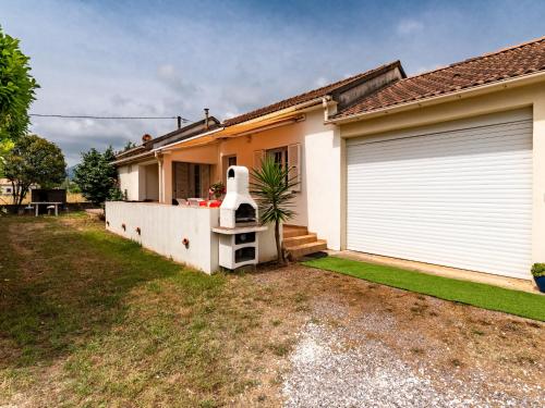 une maison avec une porte de garage blanche et une cour dans l'établissement Holiday Home Dami I-2 by Interhome, à Santa-Lucia-di-Moriani