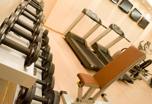 a gym with a chair and a machine at Konstantinos Palace in Karpathos Town