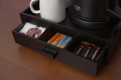 a black drawer with a cup and books at 50|50 Hotel Belmont in Ede