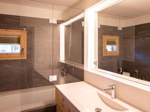 a bathroom with a sink and a glass shower at Apartment Chesa Polaschin B - B6 - Sils by Interhome in Sils Maria