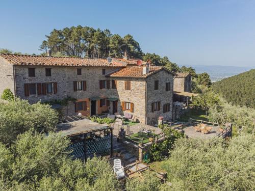 an old stone house on a hill with trees at Holiday Home Italia by Interhome in Vorno