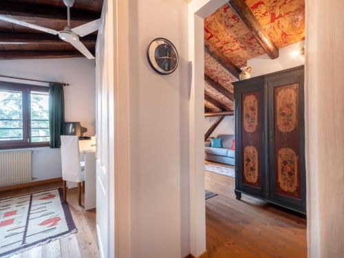 a living room with a clock on the wall at Apartment Villa Margherita-3 by Interhome in Anduins
