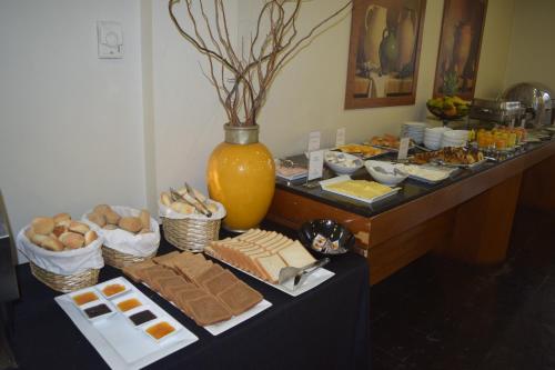 a table filled with different types of food at Park Plaza Bonaparte Boutique in Santiago