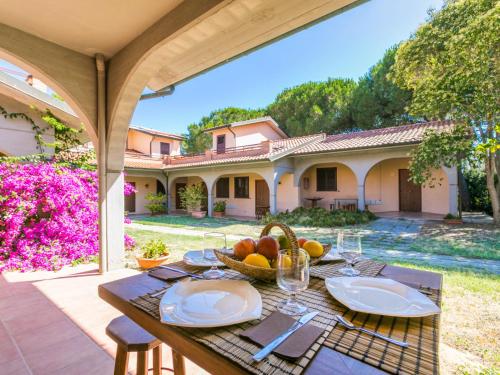 a table with a bowl of fruit on a patio at Holiday Home Bilocale - Ranch Hotel by Interhome in Scarlino