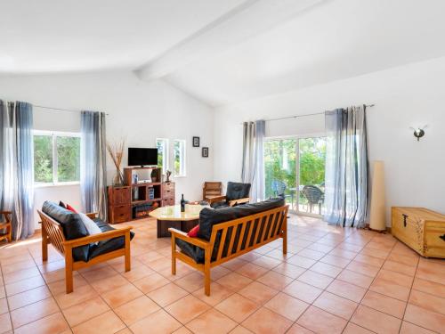 a living room with two chairs and a table at Holiday Home Monte Quercus by Interhome in Porches