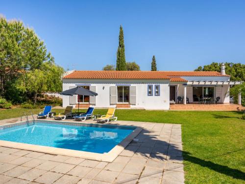 a villa with a swimming pool and a house at Holiday Home Monte Quercus by Interhome in Porches