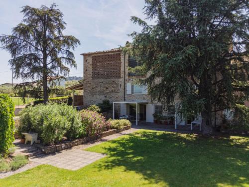 a house with a garden in front of it at Apartment Rustico dei Canali by Interhome in Castelvecchio
