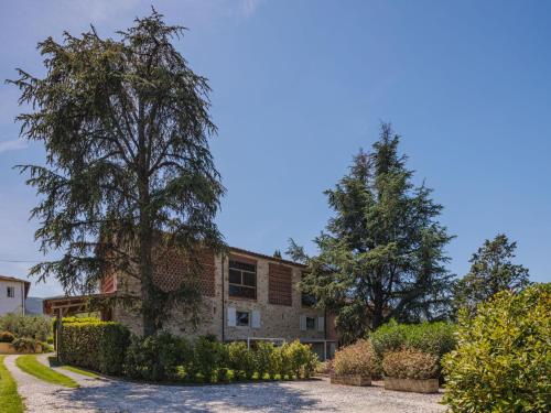 a brick building with trees in front of it at Apartment Rustico dei Canali by Interhome in Castelvecchio