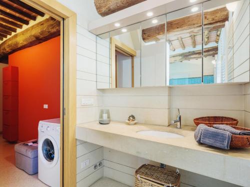a bathroom with a sink and a washing machine at Apartment Rustico dei Canali by Interhome in Castelvecchio