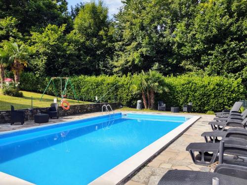 a large swimming pool with chairs and a pool at Holiday Home Oasi & Relax by Interhome in Colico