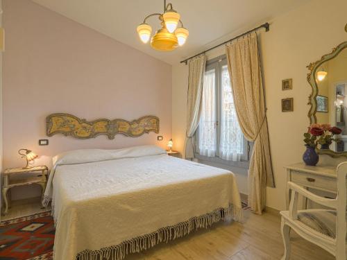 a bedroom with a white bed and a window at Holiday Home L'Orlo del Bosco by Interhome in Levane