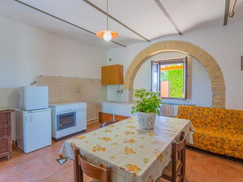 a large kitchen with a table and a couch at Holiday Home Borgo Agrituristico Il Pino-1 by Interhome in Crecchio