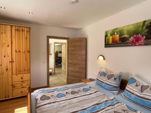 a bedroom with two beds and a mirror at Apartment Sonnseit Living by Interhome in Oberau