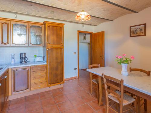 a kitchen and dining room with a table and chairs at Holiday Home Borgo Agrituristico Il Pino-2 by Interhome in Crecchio