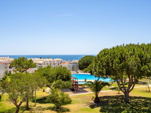 a view of a pool with trees and a playground at Apartment Quinta do Torrejão by Interhome in Porches