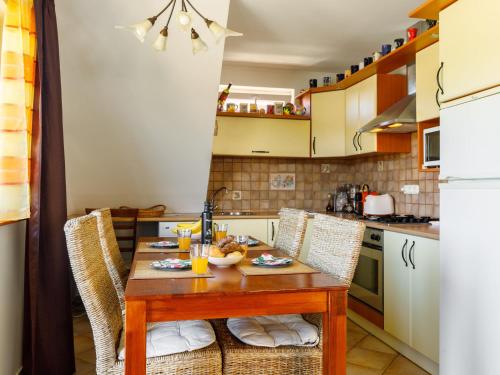 a small kitchen with a wooden table and chairs at Apartment Bocskai by Interhome in Balatonszemes