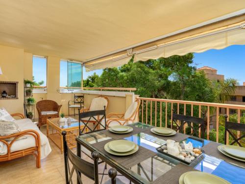 a living room with a table and chairs on a balcony at Apartment Calahonda Royale by Interhome in Sitio de Calahonda