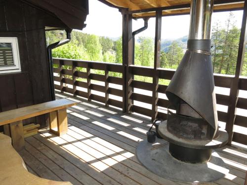 an outdoor kitchen with an old stove on a deck at Chalet Bakketoppen - SOW111 by Interhome in Øyuvstad