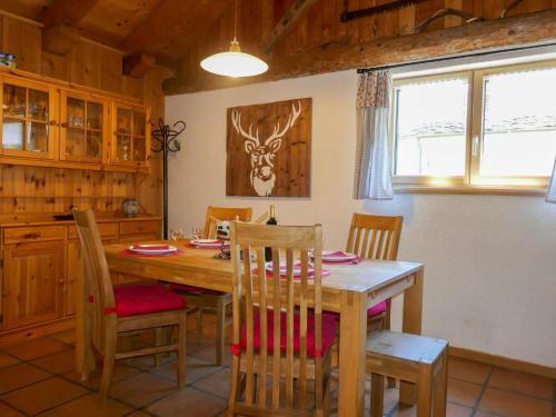 a dining room with a wooden table and chairs at Holiday Home Rustico Ingrid - MVA338 by Interhome in Semione