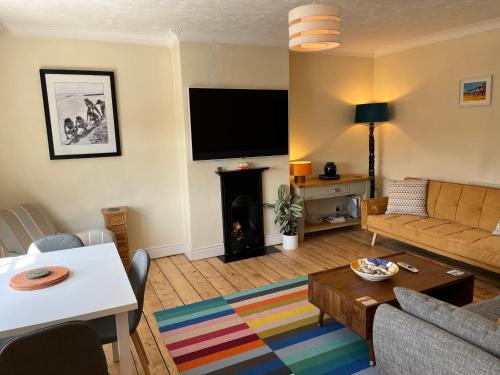 a living room with a couch and a fire place at Stunning 1-Bed Apartment in Sheringham in Sheringham