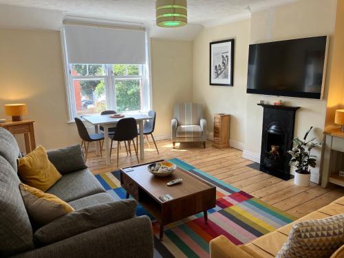 a living room with a couch and a table at Stunning 1-Bed Apartment in Sheringham in Sheringham