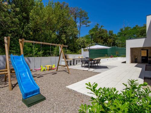 a playground with a slide and a swing set at Villa Pinnidae by Interhome in Lopar