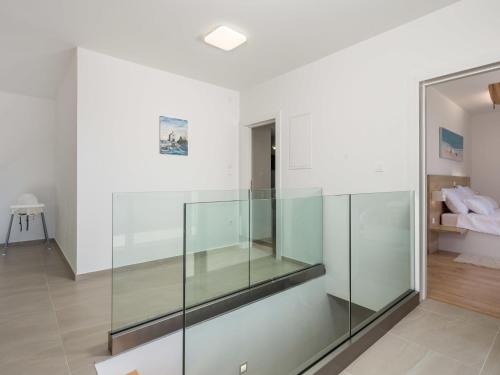 a glass elevator in a room with a bedroom at Villa Pinnidae by Interhome in Lopar