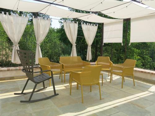 a group of chairs and tables on a patio at Holiday Home Tenuta Margherita by Interhome in Portacomaro