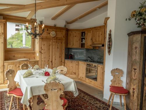 a kitchen with a table and chairs in a room at Apartment Chesa Spuonda Verde 1-7 by Interhome in St. Moritz