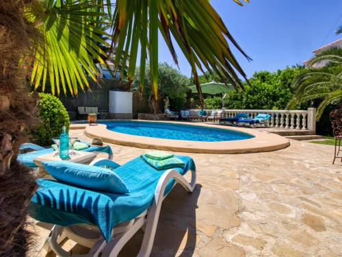 a pool with chaise lounge chairs and a swimming pool at Holiday Home Mabrouk by Interhome in Jávea