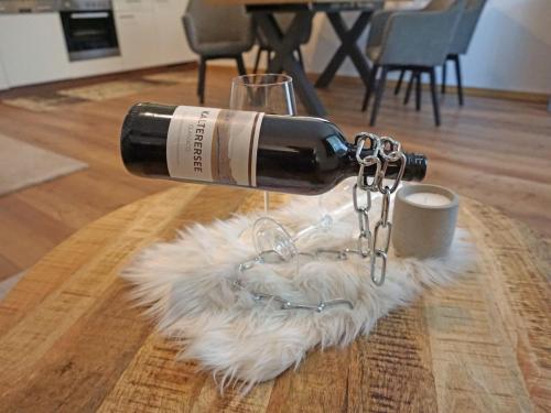 a bottle of wine sitting on top of a white rug at Apartment Jonas by Interhome in See
