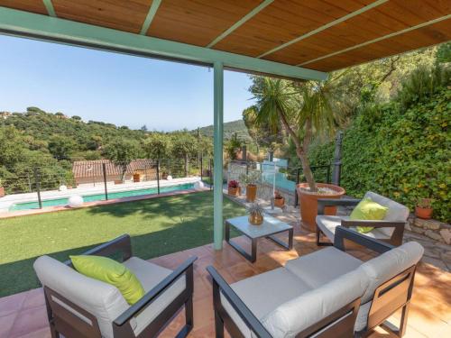 a patio with furniture and a view of a pool at Holiday Home Gloria by Interhome in Calonge